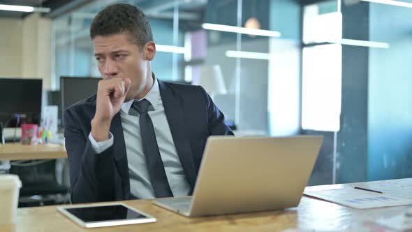 Sick African Businessman Coughing in Modern Office