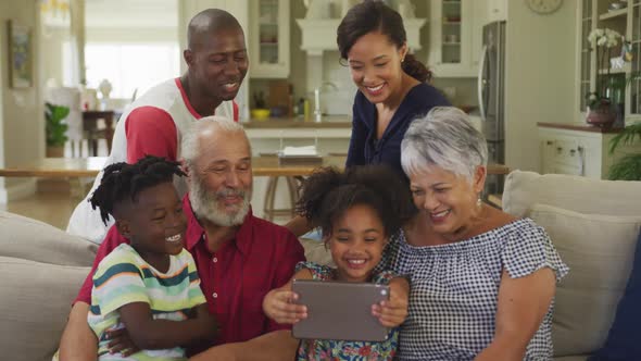 Three generation family using digital tablet at home