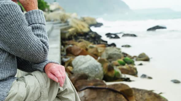 Senior man sitting on beach