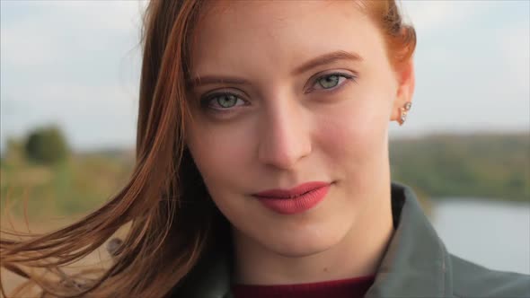 Portrait of a Petty Woman With Red Hair Standing High on a Hill, Girl the Background of Nature