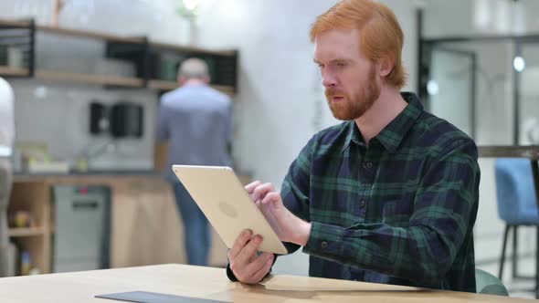 Winning Beard Redhead Man Celebrating Success on Tablet