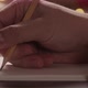 Closeup Man Writes Christmas Gifts in Notepad with a Pencil Under Warm Light in the Evening - VideoHive Item for Sale
