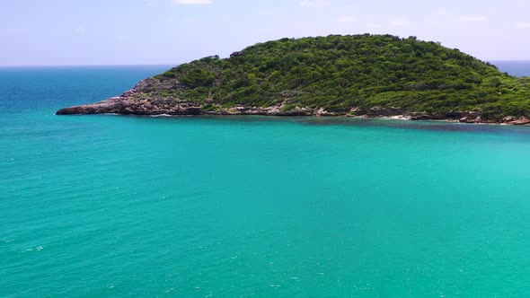Island with foliage in an azure sea,Half moon Bay,Antigua and Barbuda,Caribbean.