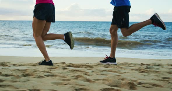 Couple Jogging Together on the Beach