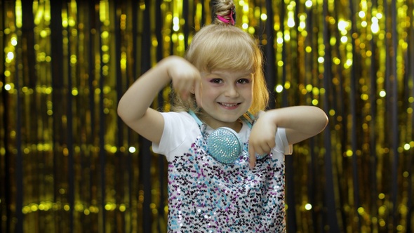 Child Asking To Subscribe, Trying To Control, Pointing Fingers Down. Little Kid Girl with Headphones