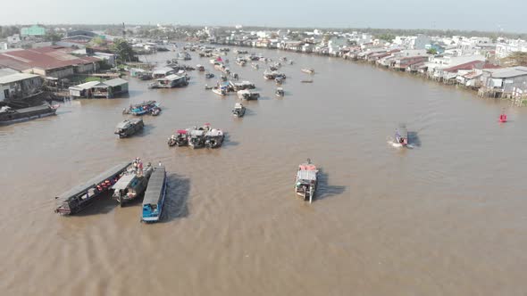 Aerial: flying over Cai Rang floating market on the river, Can Tho, Vietnam