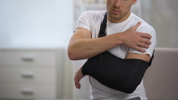 Man Wearing Arm Sling Feeling Pain in Shoulder, Result of Trauma, Orthopedics