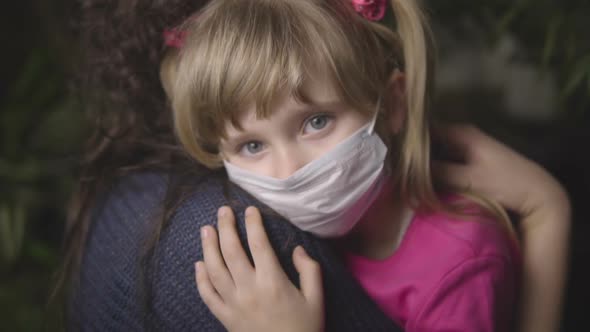 Baby with Mom in a Medical Mask