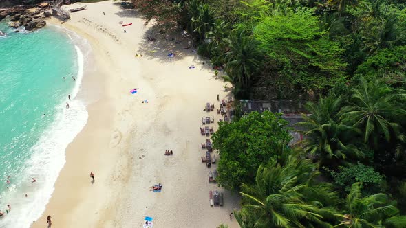 Natural flying copy space shot of a white sand paradise beach and blue sea background in vibrant 4K