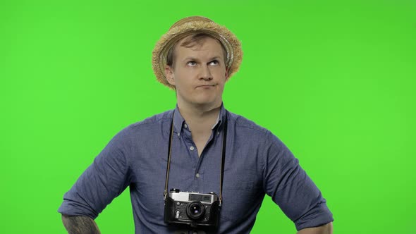 Portrait of Exhausted Man Tourist Photographer Shows Dissatisfaction. Chroma Key