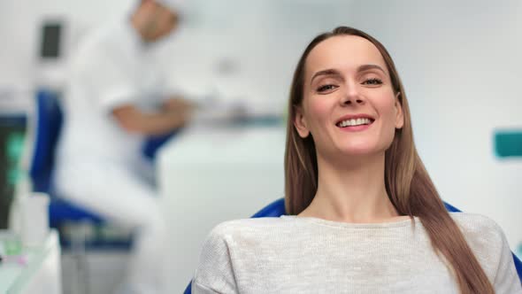 Close Up Face of Attractive Laughing Female Sitting at Stomatology Chair