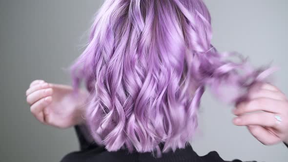 Young Pretty Woman, Back View on Beautiful Bright Purple-pink Hair.