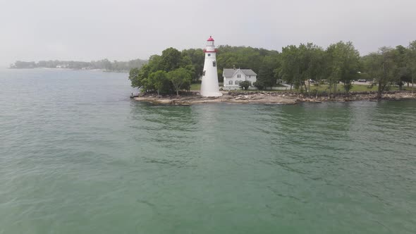 Marblehead Lighthouse along Lake Erie in Ohio drone fly over water.