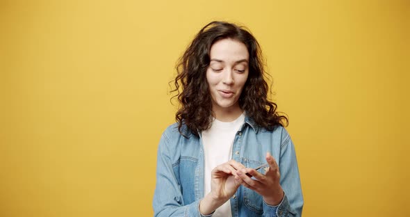 Happy Smiling Girl Posing with a Credit Card in Her Hand Filmed in the Studio