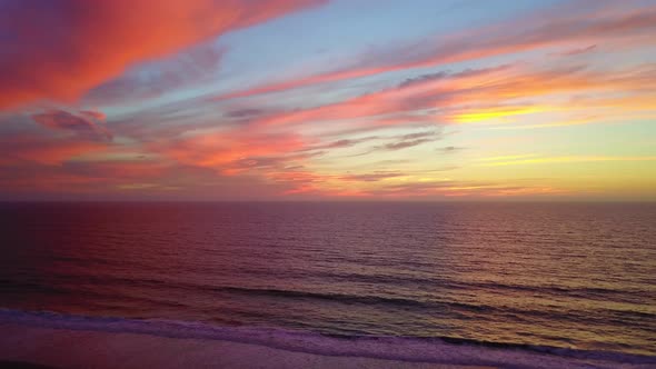 Aerial drone view of a sunset at the beach over the ocean