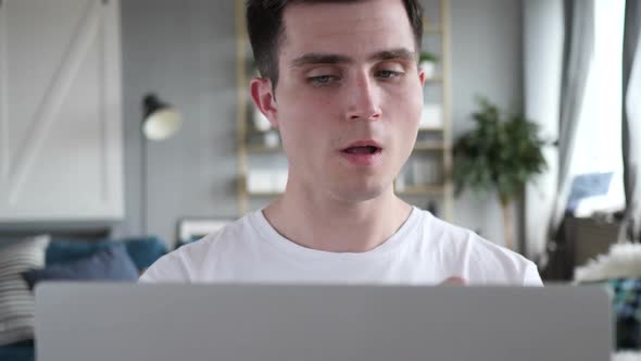 Close Up of Man Coughing and Working on Laptop