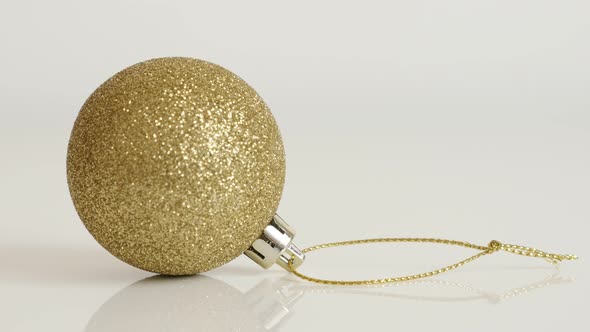 Shiny gold color bauble with sequins close-up 4K 2160p 30fps UltraHD tilting  footage - Golden Chris