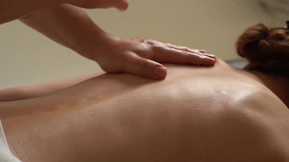 Closeup Hands of Male Masseur Doing Back Massage to Young Unrecognizable Woman in Spa Centre