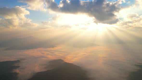 Aerial view from drone, Epic sunbeam over clouds mountains. 4K aerial shot on sunrise