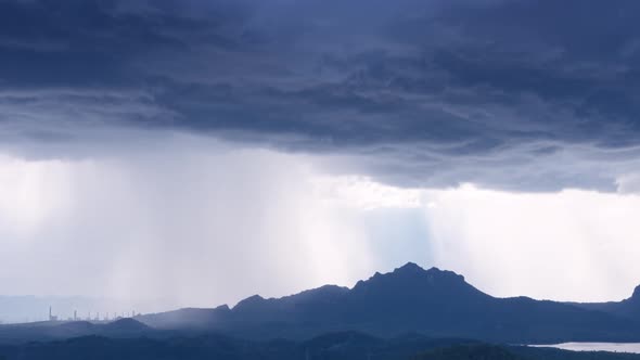 Rain storms and black clouds moving over the mountains.