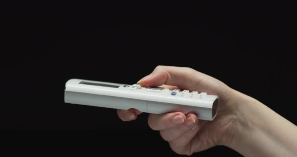 Hand pressing a remote control