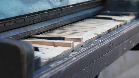 Old Rusty Piano Outdoors Close Up. Overview of a Keyboard of an Old Piano. Antique Music Instrument