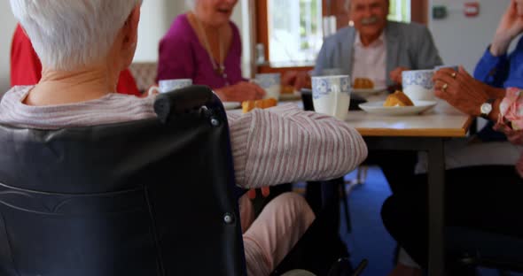 Group of Mixed-race senior friends eating breakfast on dining table 4k