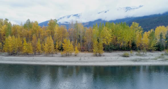 Autumn forest and mountain ranges along the lake