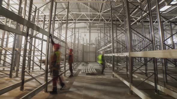 Workers Assemble Metal Racks in Spacious Plant Warehouse