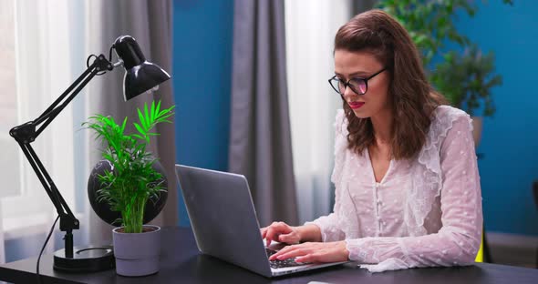 A Young Beautiful Businesswoman Works Remotely From Home