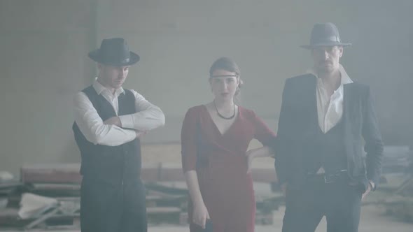 Portrait Two Confident Well-dressed Men Standing in Two Sides of a Woman in Red Dress