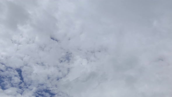 Time lapse shot of blue sky with fast white clouds inement during summer day