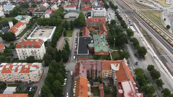 Ystad city side near railway tracks with colorful buildings, aerial drone view