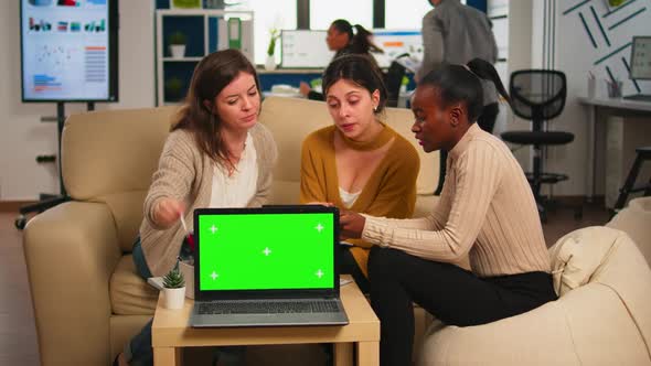 International Business Team Talking in Back of Mockup Laptop