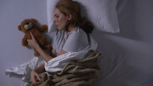 Female Violence Victim Hugging Teddy Bear Toy, Crying in Bed, Painful Emotions
