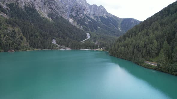 Aerial view of the green mountains forest and lake in Dolomites, Italy