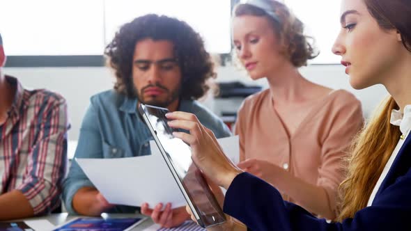 Business executive using digital tablet in meeting