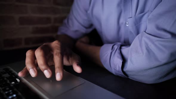 Young Man Working on Laptop Stealing Personal Data