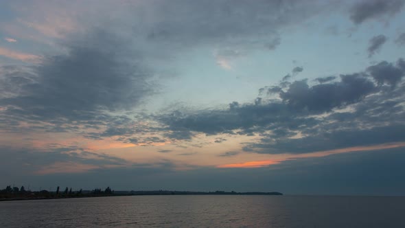 Clouds With Orange Sunrise On A Beautiful Sky In The Morning Over The River, Time Lapse