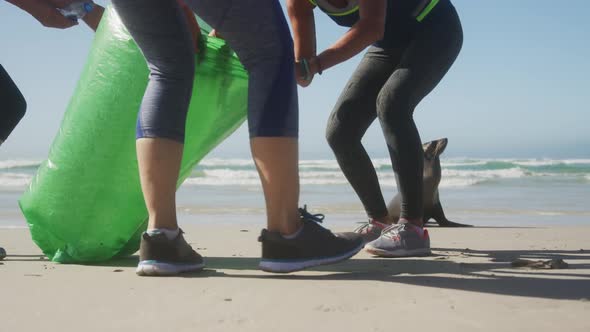 Athletic women cleaning at the beach