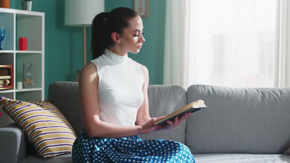 Young Woman Is Reading Book
