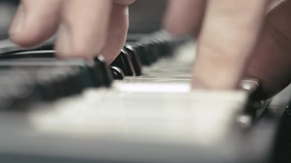 Musician's hands play keyboards, macro shot.