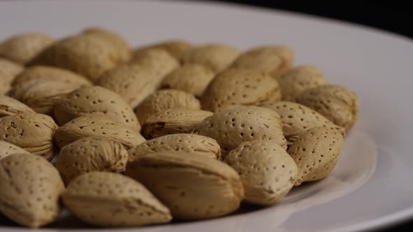 Cinematic, rotating shot of almonds on a white surface - ALMONDS