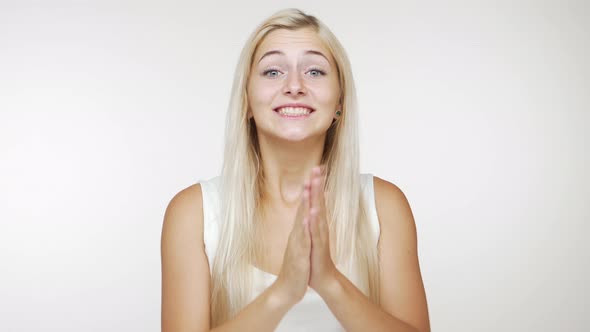 Caucasian Happy Young Woman with Long Blond Hair Expressing Approval Showing Thumb Up Smiling