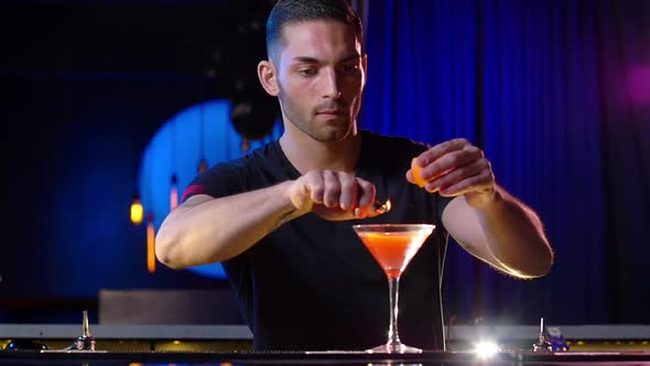 Male Bartender Preparing a Flaming Cocktail Drink