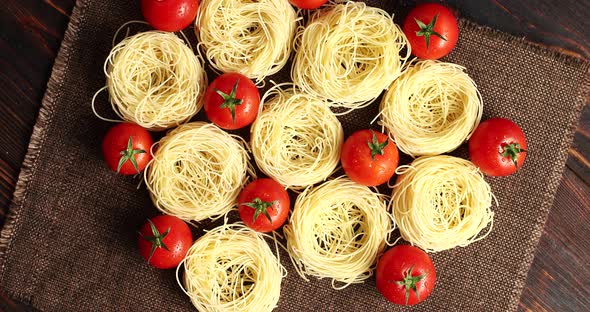 Uncooked Pasta Bunches and Tomatoes