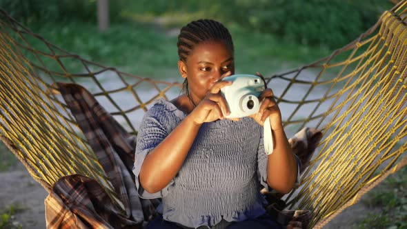 Front View Skilled African American Female Photographer Taking Photos with Camera in Slow Motion