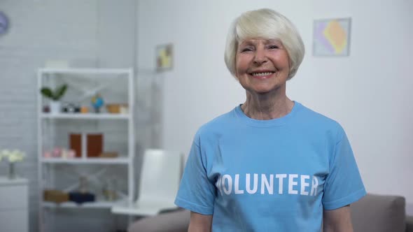 Smiling Senior Lady in Volunteer T-Shirt Looking Camera, Charity Organization