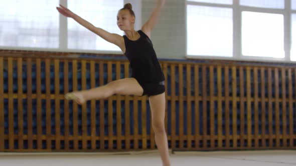 Athletic Girl Practicing Acrobatic Movements