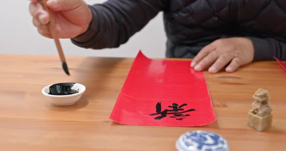 Man write chinese calligraphy for lunar new year